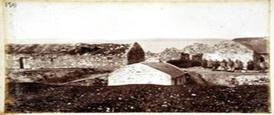 .  A new house with a chimney buried out of the wind in a Donegal clachan.